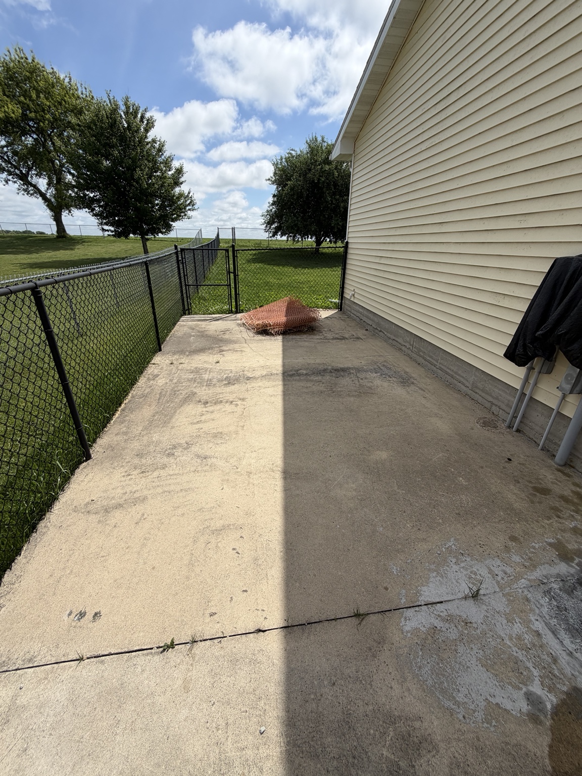 Concrete pad showing dirty side vs cleaned side