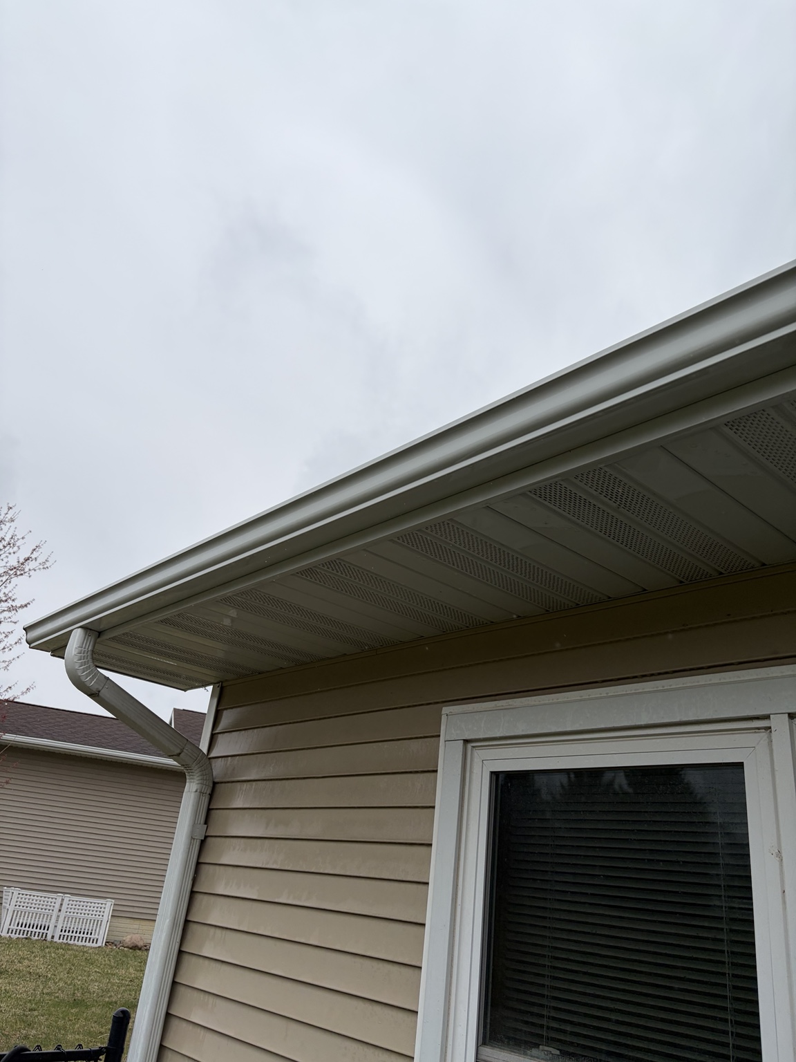 Clean gutter and downspout along home eave
