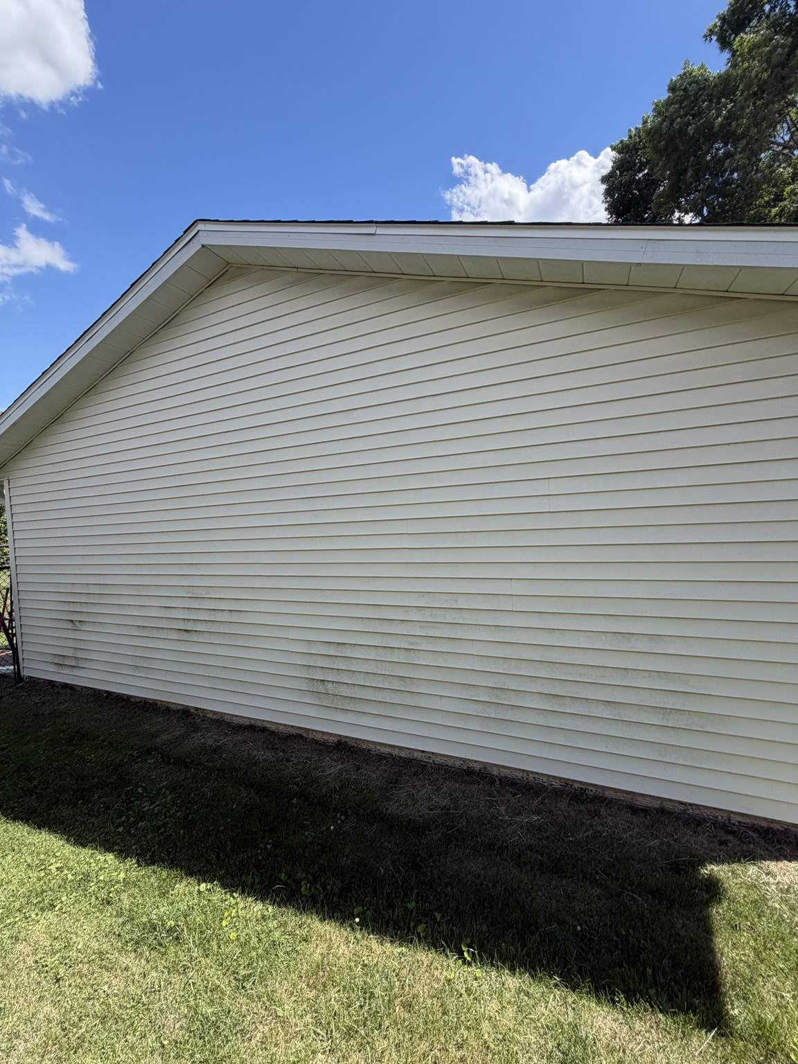 Gable end of home with dirty siding